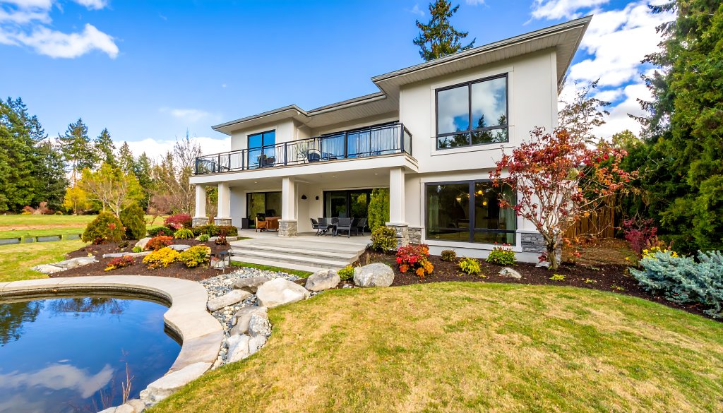 Modern Two Story Villa with Glass Balcony Stone Accents and Private Garden Pond.jpg
